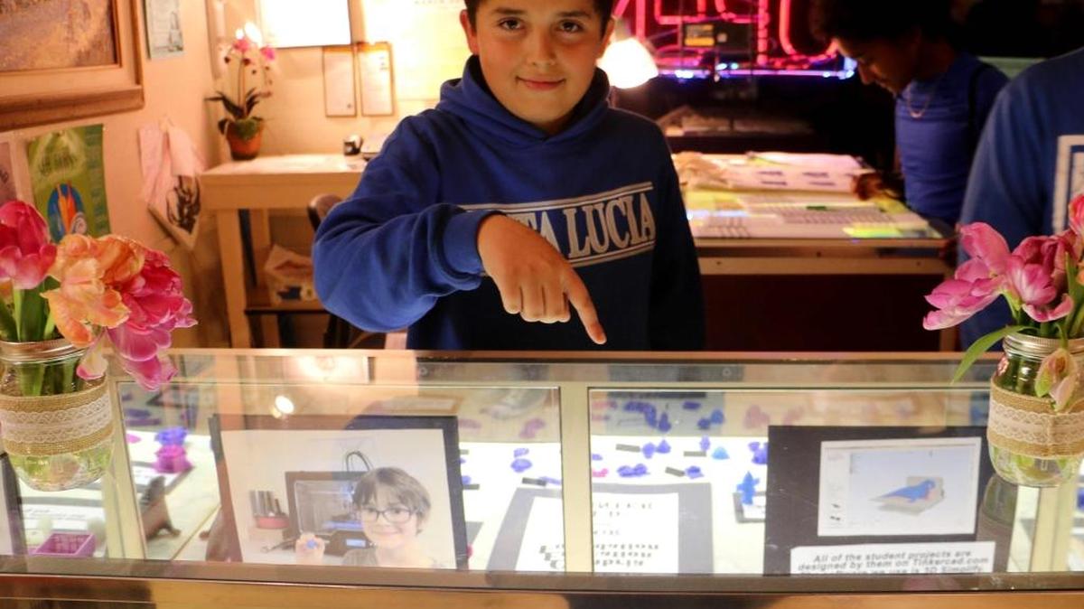 Estiban Garcia, a sixth grader, shows off his 3-D art project at the Youth Art Month Art Show.