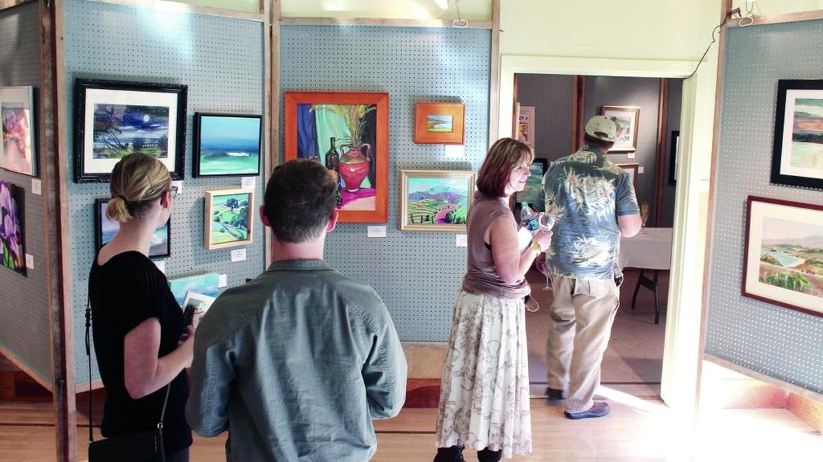 Visitors peruse artwork on display at last year’s Cambria Art & Wine Festival at the Veterans Memorial Building, Jan 24, 2015. This year’s event, set for Jan. 29-31, will be at several sites in Cambria.