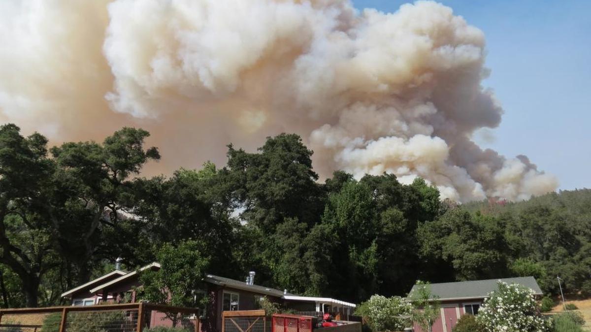 Smoke from the Chimney Fire billows up behind the columnist’s house in the Santa Lucia range.