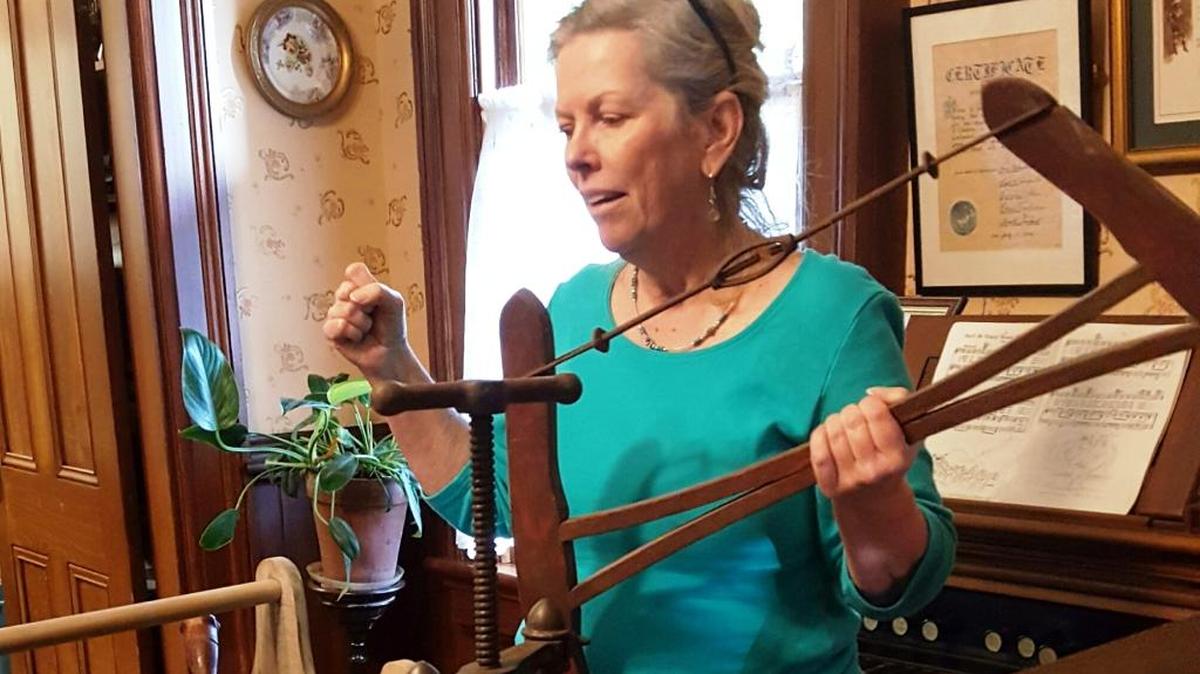 Terry Shue demonstrates newly acquired antique tools for interactive activities and display at the Cambria Historical Museum.