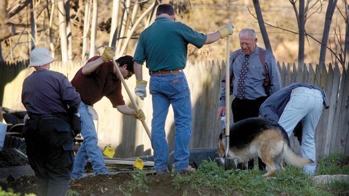 Law enforcement personnel, a cadaver dog and forensic experts from the San Luis Obispo County Sheriff Department dig for evidence behind a Paso Robles home in this photo from Jan. 31, 2002.