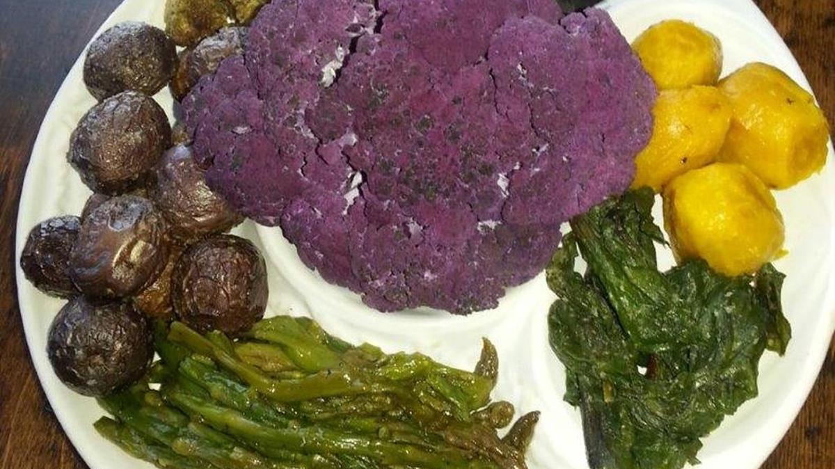 Serve asparagus, baby purple potatoes, Romanesco broccoli, purple carrots, golden beets and their greens, crowned by purple cauliflower, all tossed in olive oil, salt and pepper and roasted at 400 degrees.