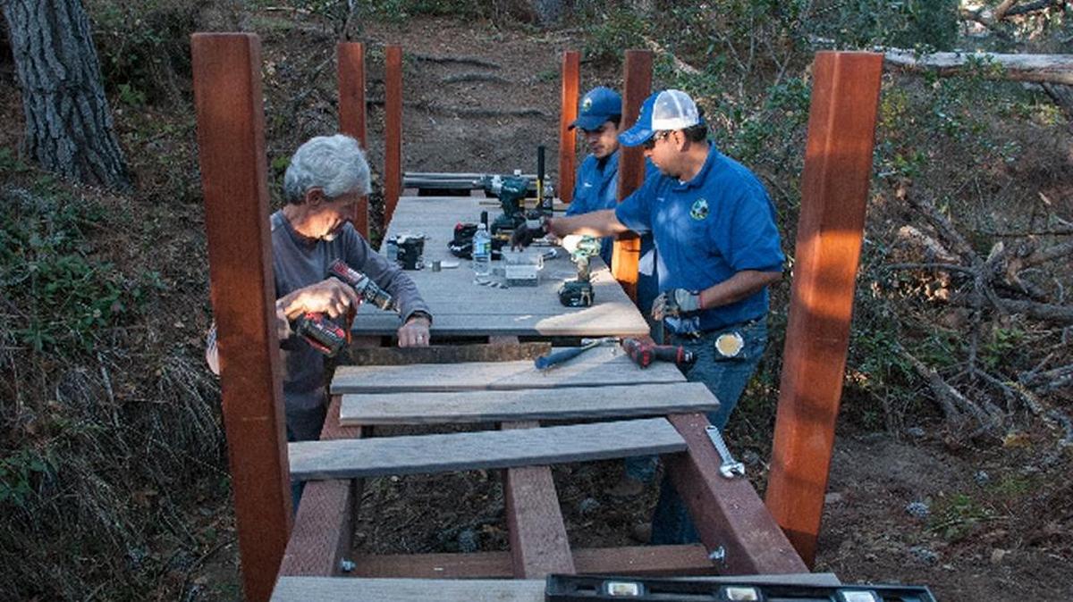 Brian Morgan, Carlos Mendoza and Alberto Novas work on constructing the new Trenton bridge on the Fiscalini Ranch Preserve.