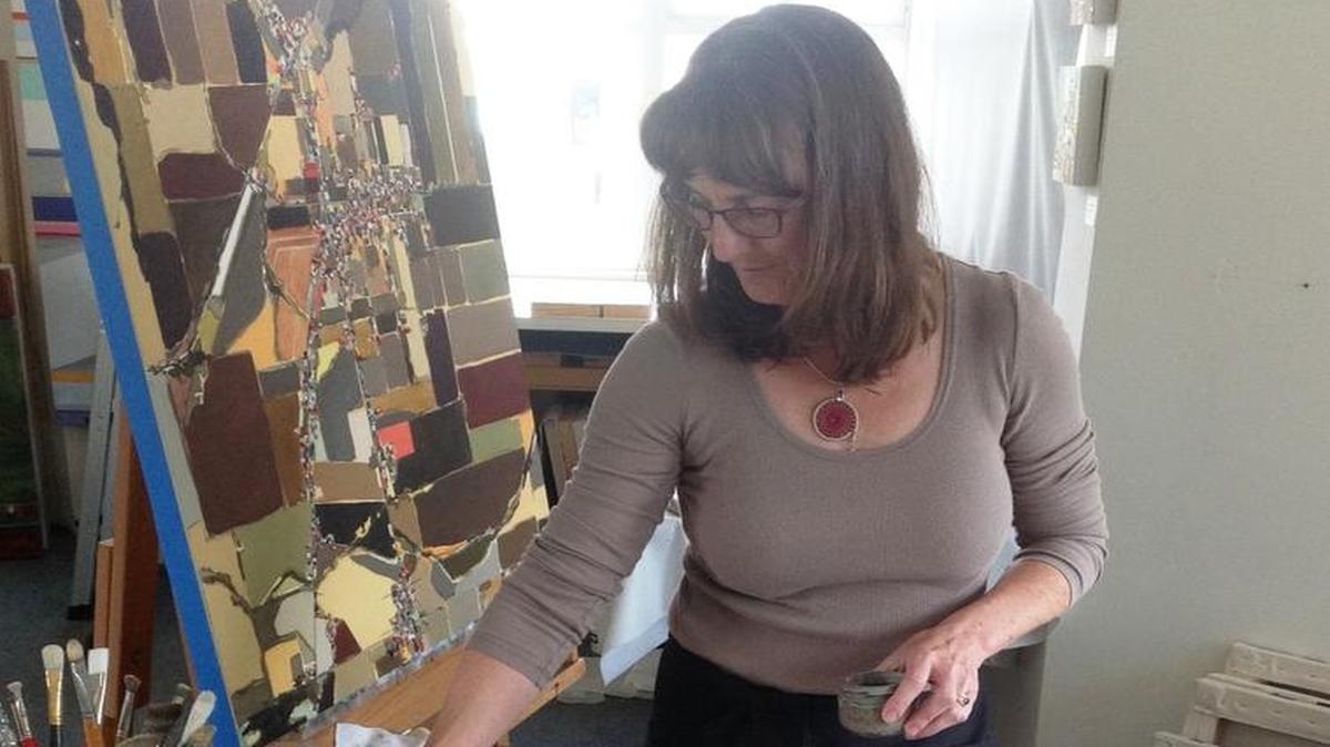Los Osos artist Glynis C. Tinglof at work in her studio.