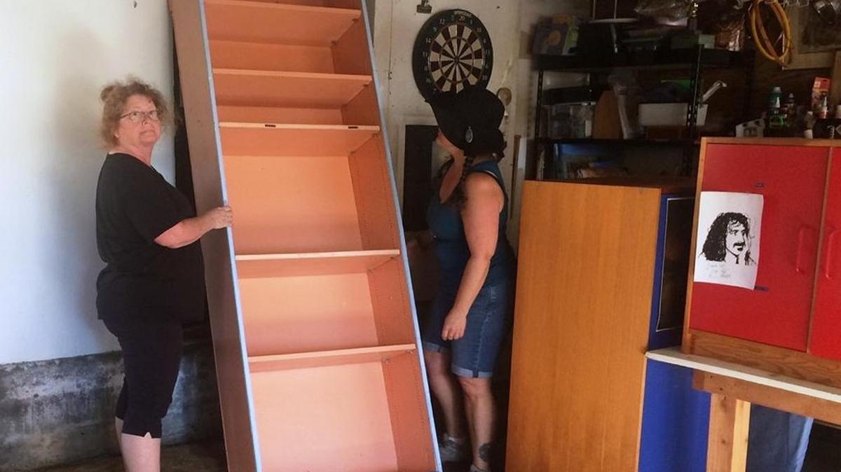 Friends help clean up the columnist’s garage after it flooded in recent rains.