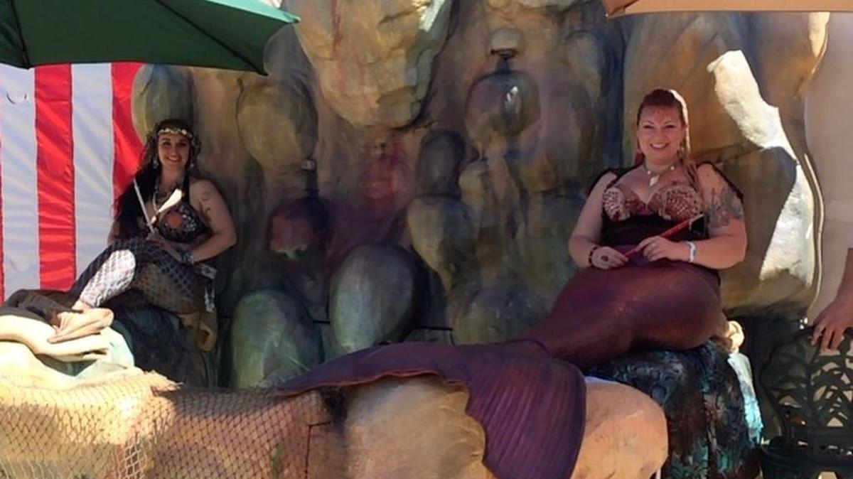 Mermaids Kai and Kiki, resting on the specially made-for-them grotto at the Medieval Fantasy Fair.