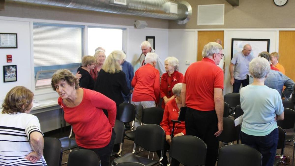 Members of the audience talk during a recess in the meeting to select an appointee to fill a vacant seat on the Cambria Community Healthcare District board.
