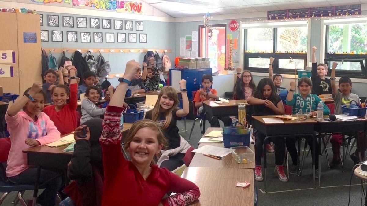 Members of Sarah Moore’s fifth-grade class show off their wristbands in a display of solidarity to end malnutrition around the world.