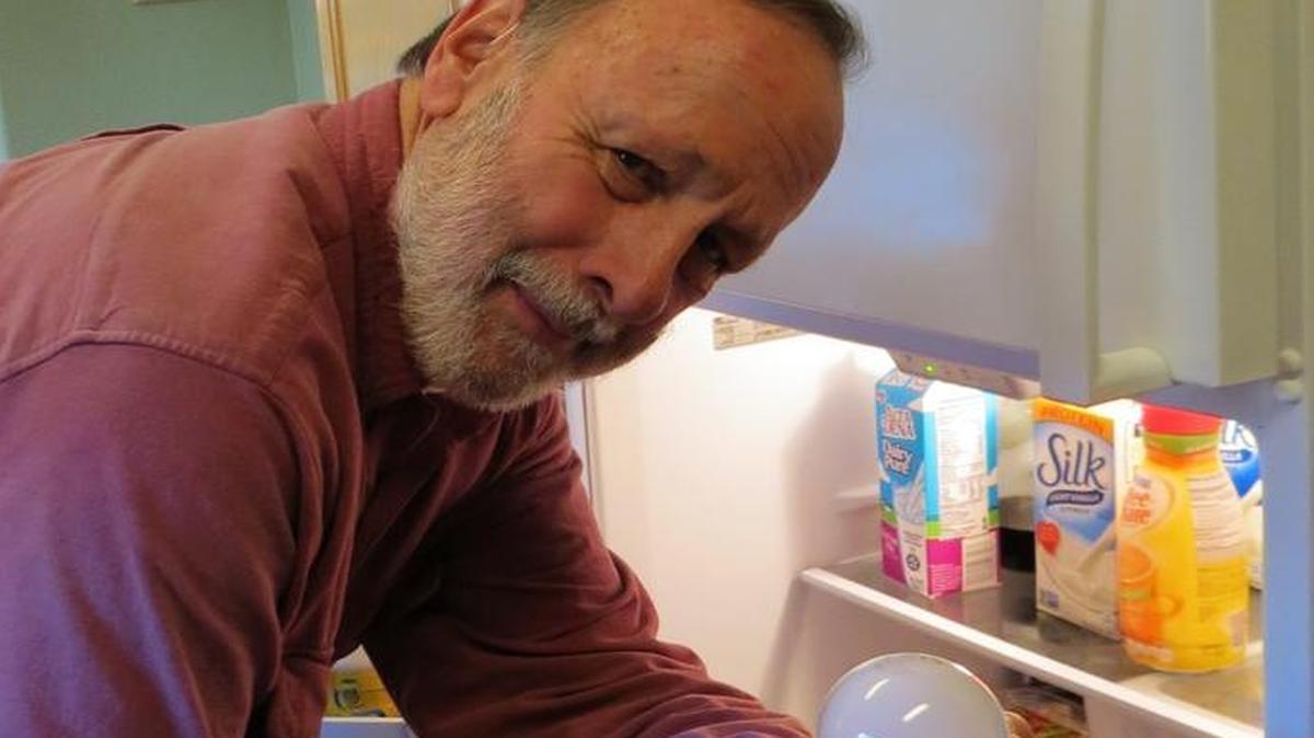 The columnist’s husband, John Rhoades, likes the bright idea of having an electric refrigerator.