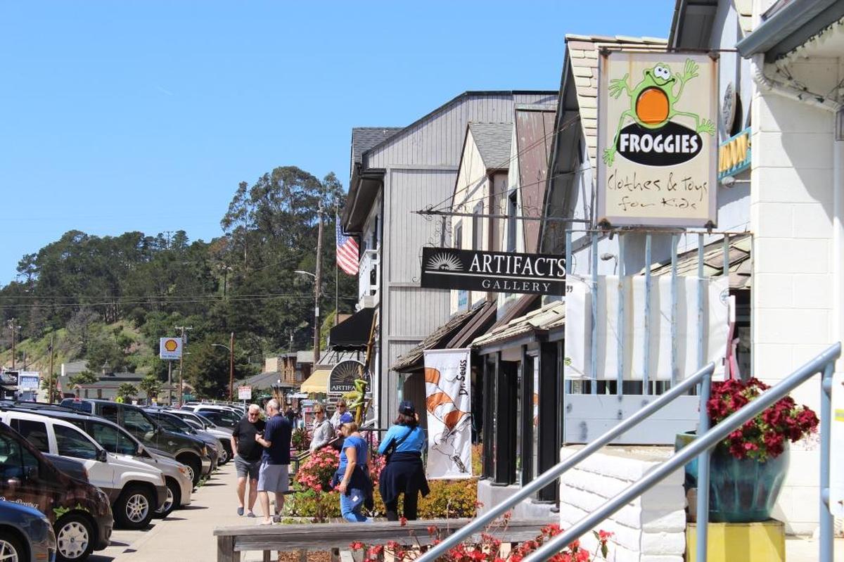 Pedestrians visit shops in Cambria’s West Village in 2016.