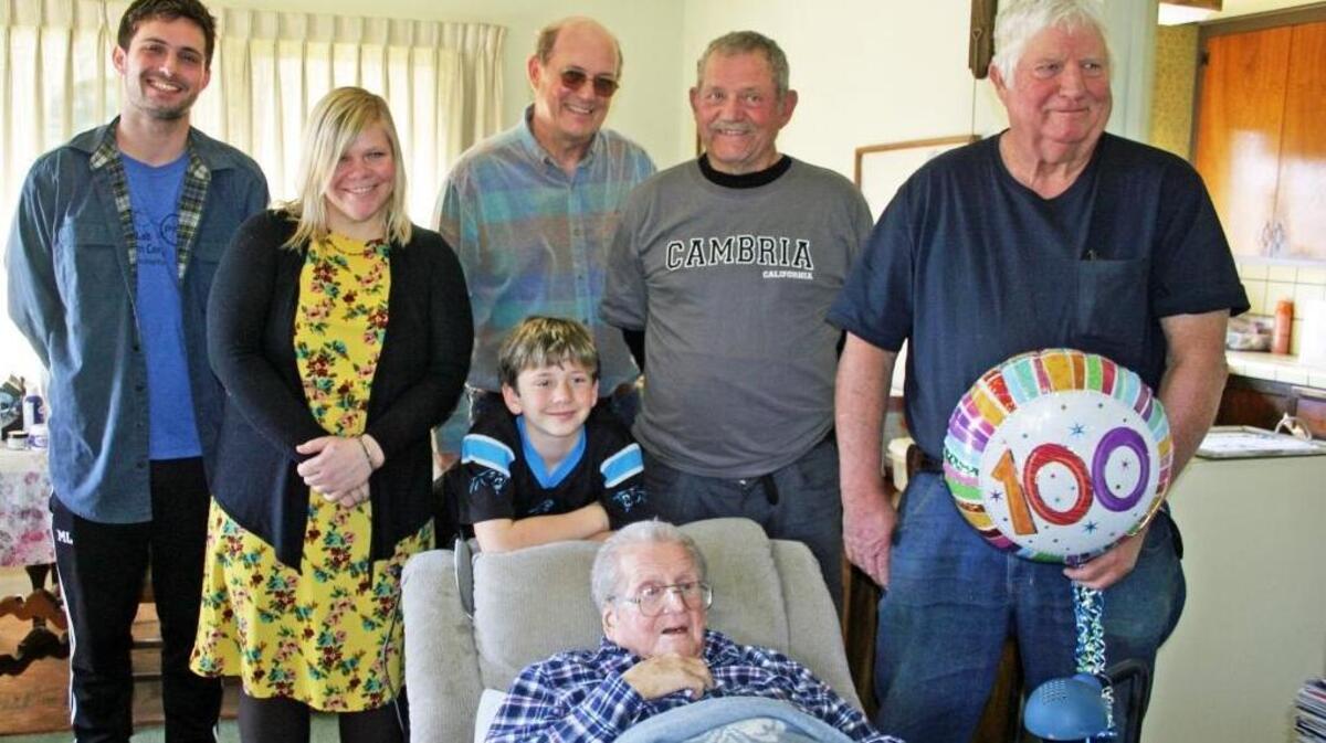 Robert Lyons with three generagions of descendants. Counter-clockwise from Lyons are son William (Bill) Lyons of Watsonville; son Robert W. (Bob) Lyons of Watsonville, wearing the Camria sweatshirt; son Nicholas (Nick) Lyons of Cambria; granddaughter Julia Neuman of Arcata (daughter of son Bob); grandson Max Lyons of Oakland (Nick’s son), and great-grandson Lincoln Neuman of Arcata (leaning on back of chair).