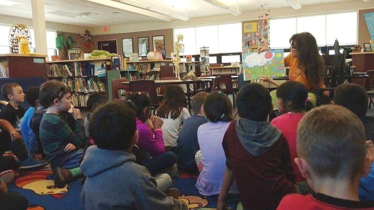 The columnist reads to Cambria Grammar School students.