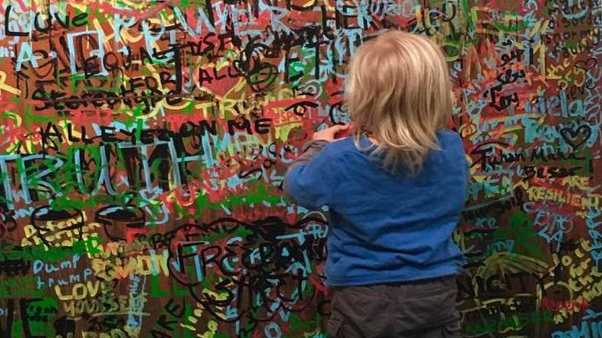 A child checks out wall art during the L.A. Art Show at the Los Angeles Convention Center in January.