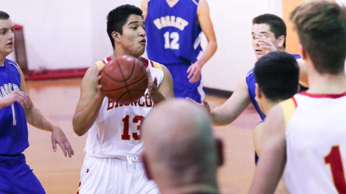 Junior center Roberto Cueva has been strong under the basket for the 5-0 Broncos. Here he controls a rebound Jan. 8 against Valley Christian Academy.