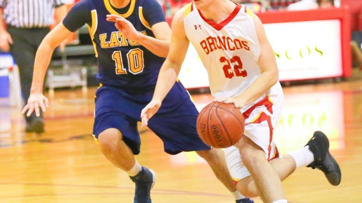 Coast senior Sam MacKinnon drives past a Laton defender Friday night in Cambria. He scored 20 points and grabbed nine rebounds in the two home games Jan. 6 and 7.