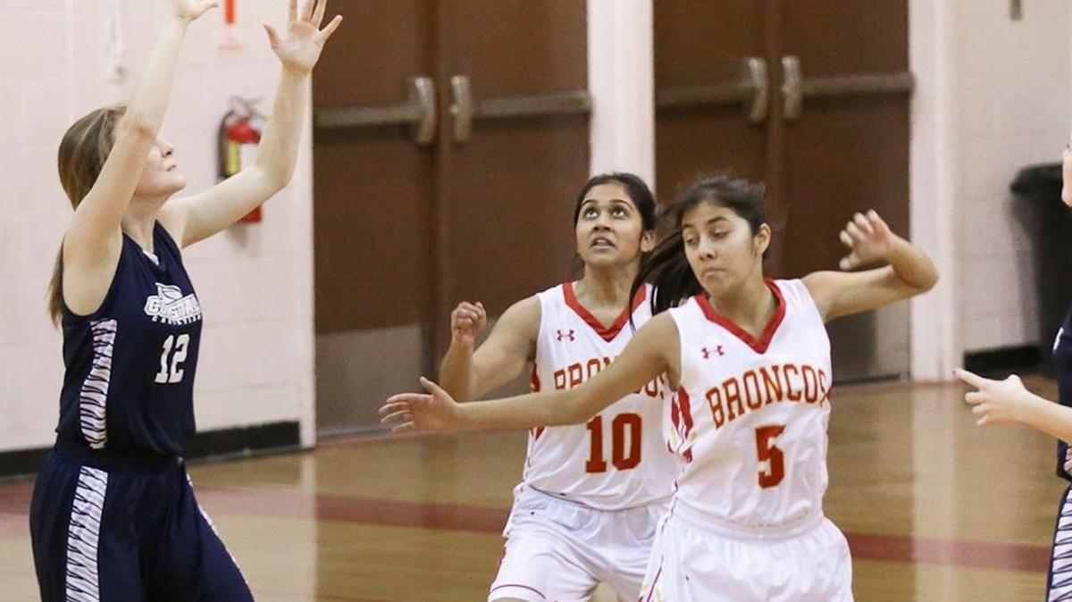 Senior Rima Panchal (10) and junior Fabby Gonzalez (5) battle for a rebound against Coastal Christian during the regular season.