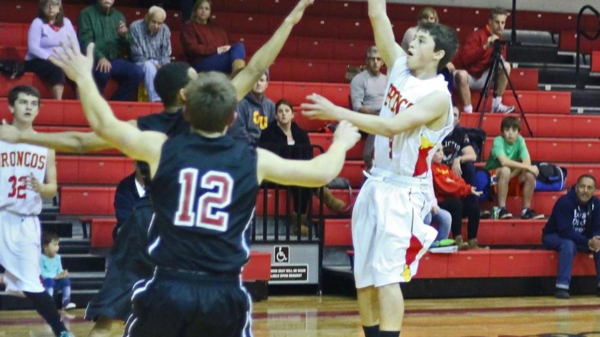 Junior guard Auggie Johnson has been hitting 3-pointers with regularity early in the season. Here he takes a shot in league play in 2014.