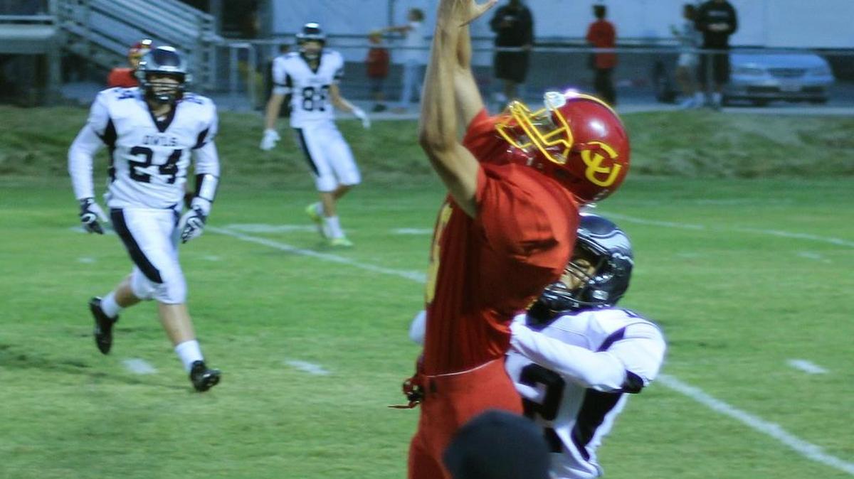 Senior Roberto Quintero played at a high level as a receiver, but his defensive acumen led to his being placed on the All-Coast Valley League second team for defense. here he goes up for a pass against Fresno Christian.