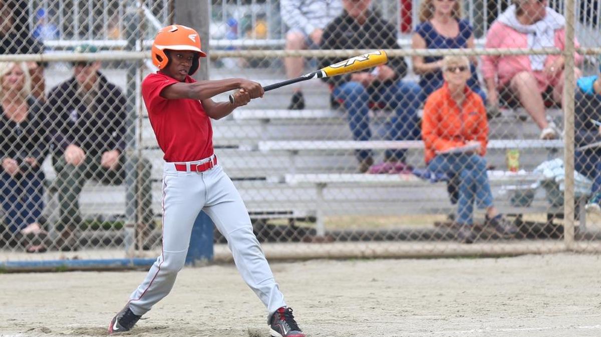 Cambria Reds player Ahnase Martin already has two home runs in early-season Little League play. Here he connects last year for the Reds.