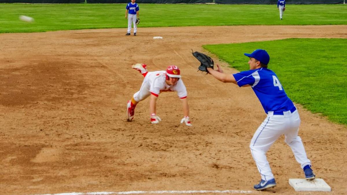 Broncos catcher Lane Sutherland tries to stretch a double into a triple after his booming drive deep into left field, but the throw beats him at third.