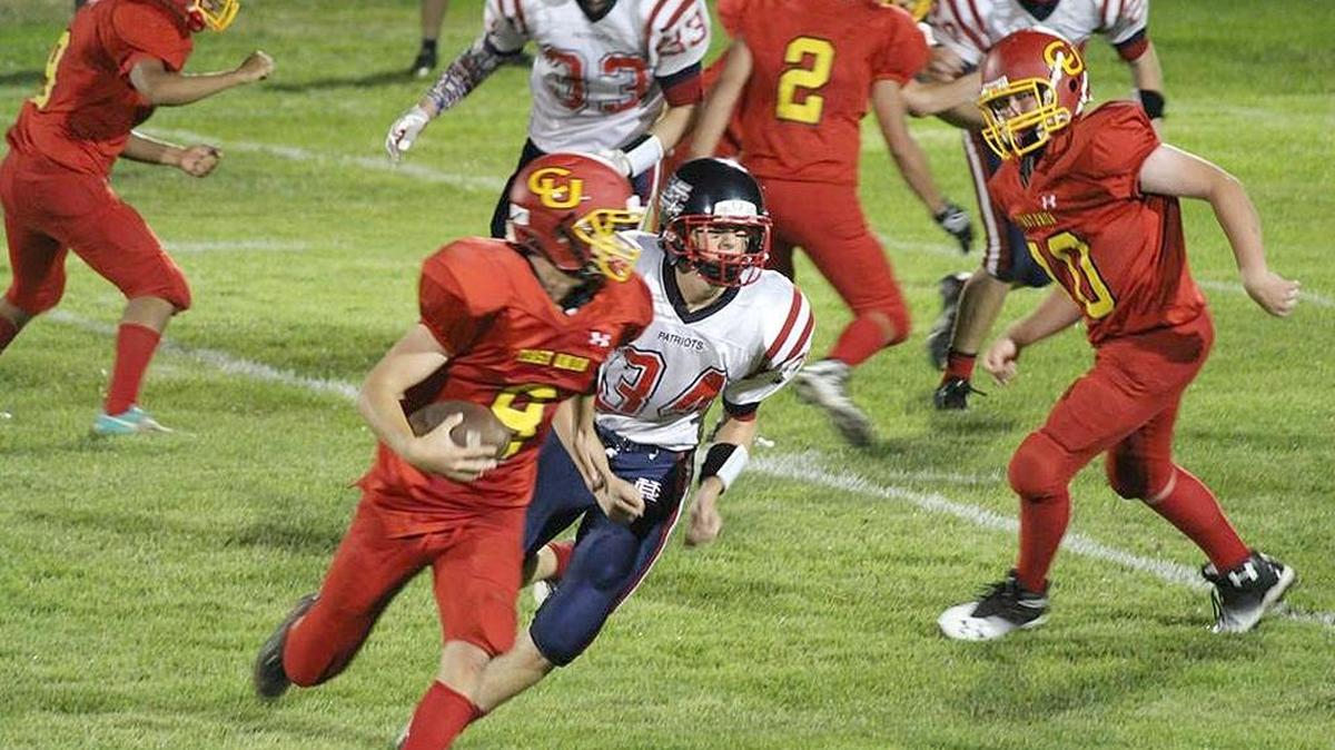 Coast Union quarterback Jack MacKinnon sprints to his right under heavy pressure from the Hesperia Christian defense during the first half of the Broncos’ 75-0 loss to the visiting Patriots in Friday, Aug. 26’s, season opener for both teams.