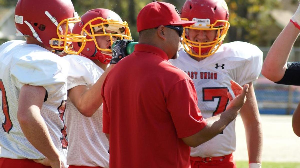 Thom Holt talks to members of the Coast Union football team this past fall.