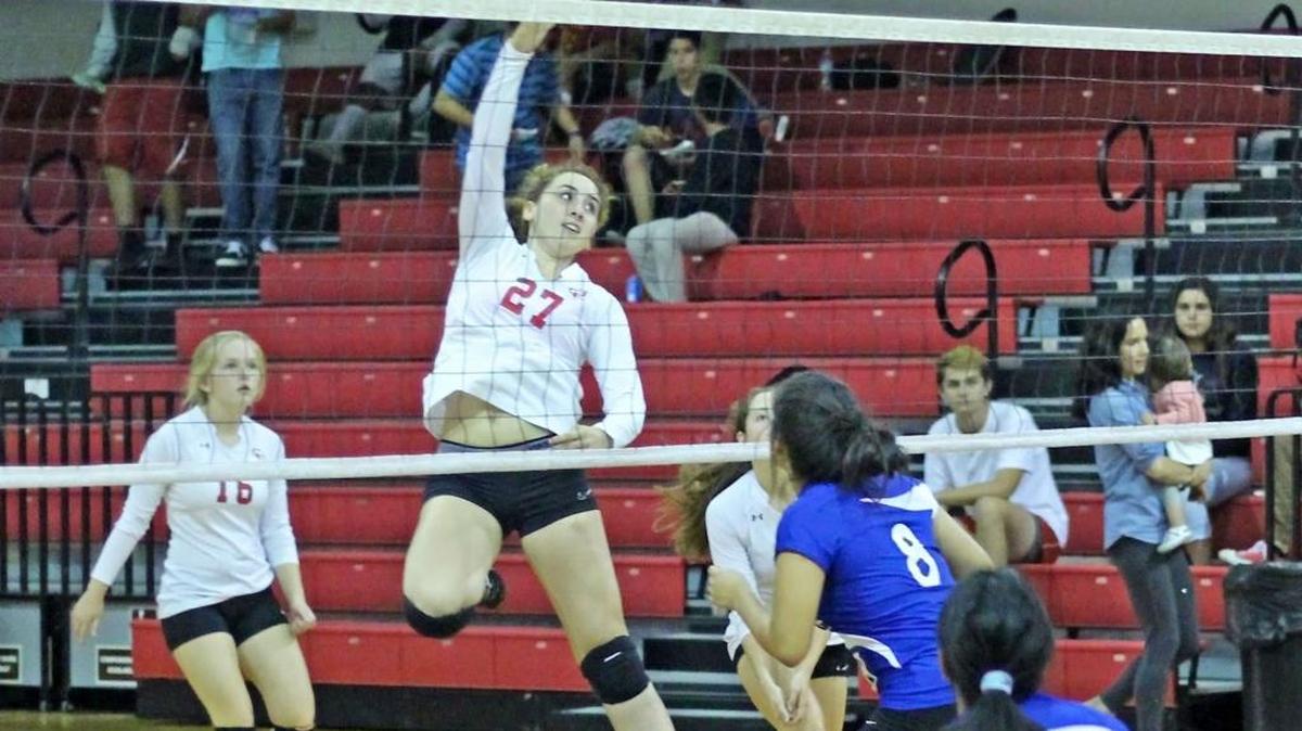 Middle hitter Emily McAvoy connects on a slam in Coast Union’s 3-0 victory over Shandon on Oct. 22. Reagan Kniffen (No. 16) waits for a possible return.