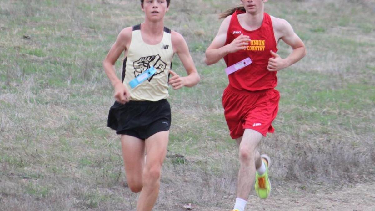Junior runner Paul Butterfield, right, seen here in the All-County High School Championships on Oct. 27, was the top Coast Union runner for the third straight year.