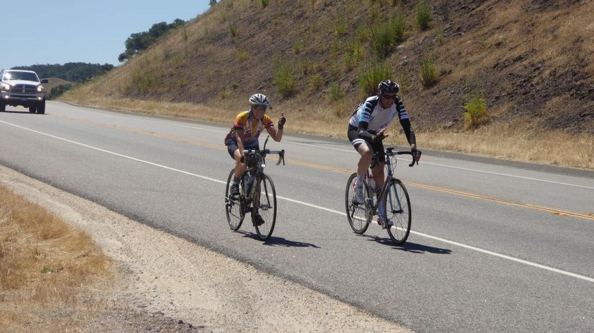 Two century riders head back down Highway 46 into cooler weather after braving 100-degree conditions over the grade during the Gene Cerise Memorial County Coast Classic bike ride Saturday, June 25.