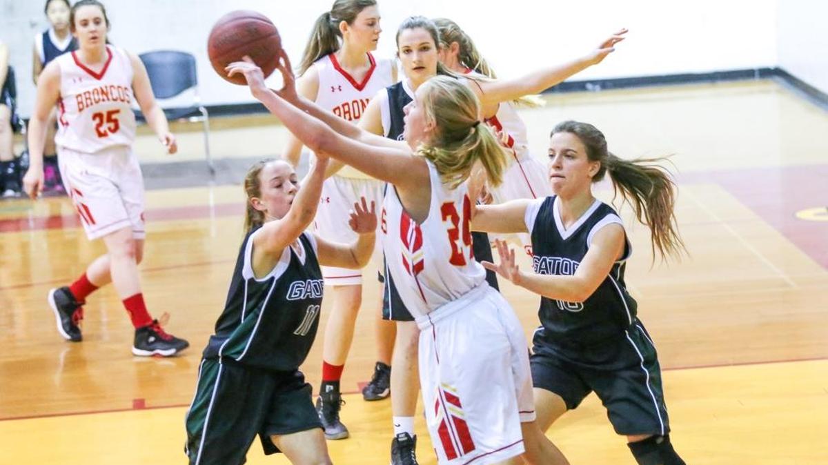 Freshman Ellie Kennedy battles for control of the ball against Newbury Park Adventist in a CIF playoff game Thursday night, Feb. 16. Kennedy scored six points in the 23-14 Coast Union victory.