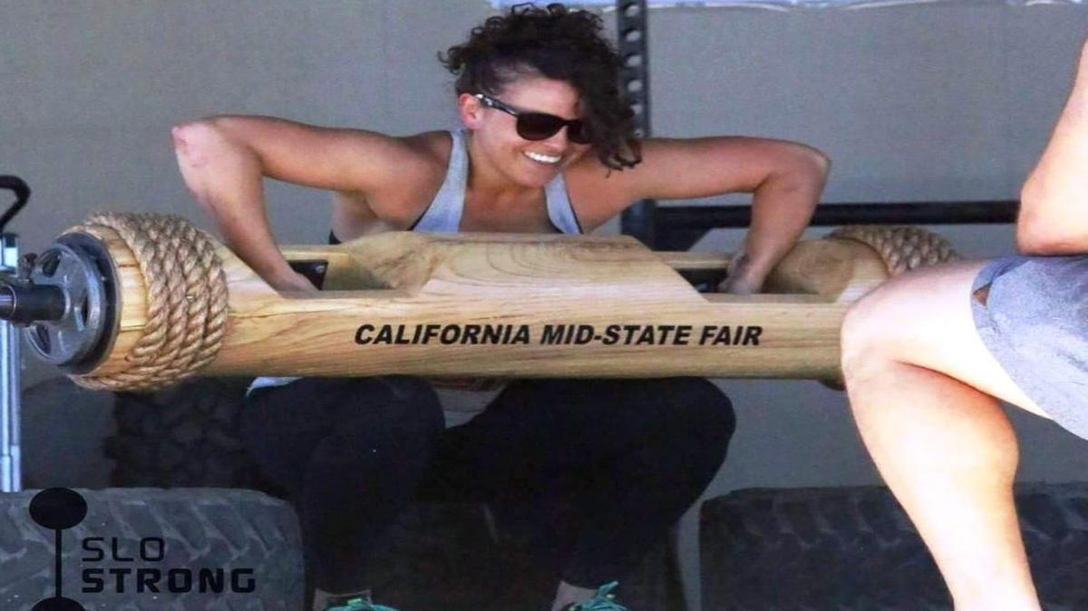 Coast Union’s supervisor of food and nutrition xervices, Christina Lawson, takes part in the Log Clean and Press portion of the Strongest Women contest July 30 at the California Mid-State Fair. Here, Lawson participates in the “Log Clean and Press.”