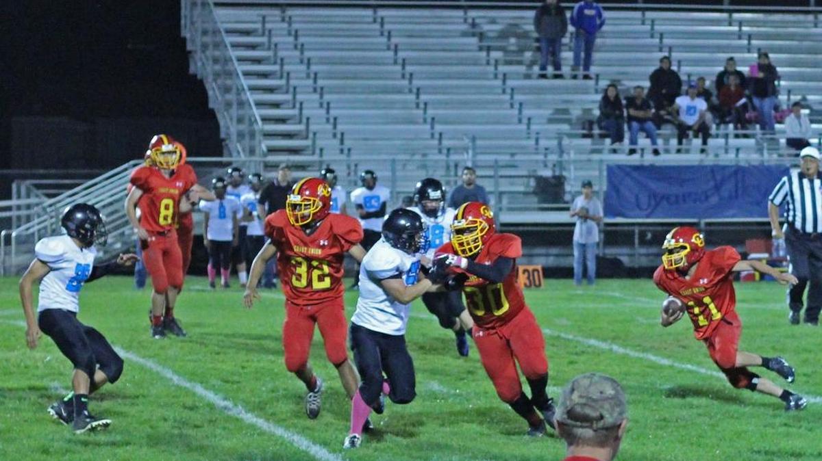 Jimmy Welch (30) blocks for Alam Ramirez (11), who picked up 285 yards from scrimmage Friday night against Cuyama Valley. Roberto Cueva (32) and Jack MacKinnon (8) are also part of the action.
