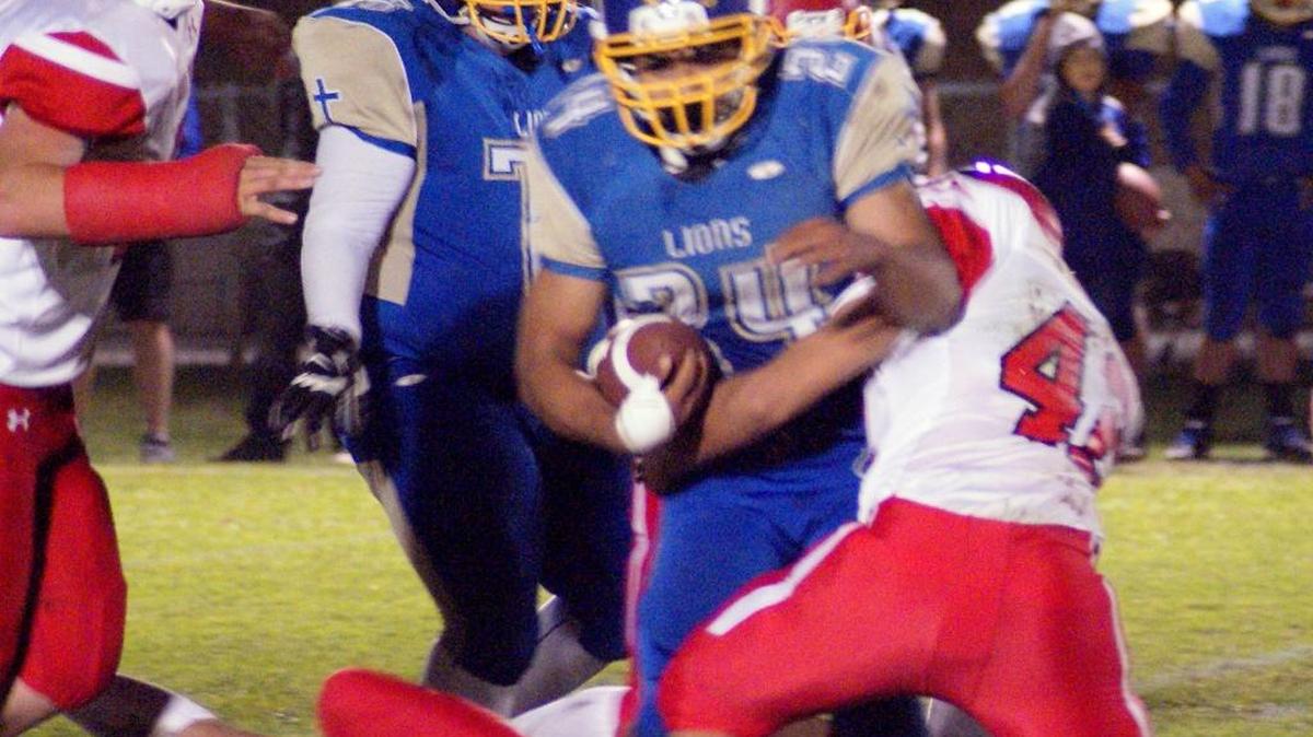 Damien Fernandez (42) tackles the Valley Christian Academy’s leading rusher, Adam Aldana (24), who gained 325 yards on 25 carries against Coast Union on Friday night, Oct. 20.