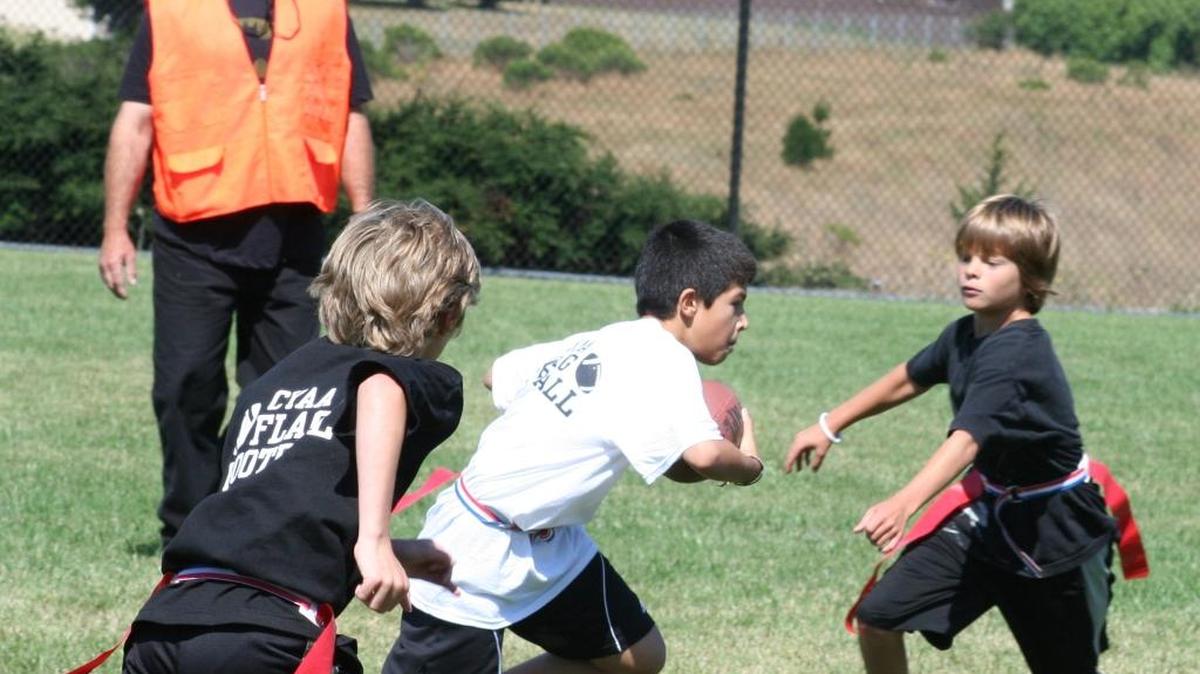 The last CYAA flag football program in 2012 featured a game with Fidel Figueroa (white shirt with the ball), Beau Burgess (approaching the Figueroa), Will Stephenson (chasing Figueroa) and CYAA leader/referee Norm Martin.