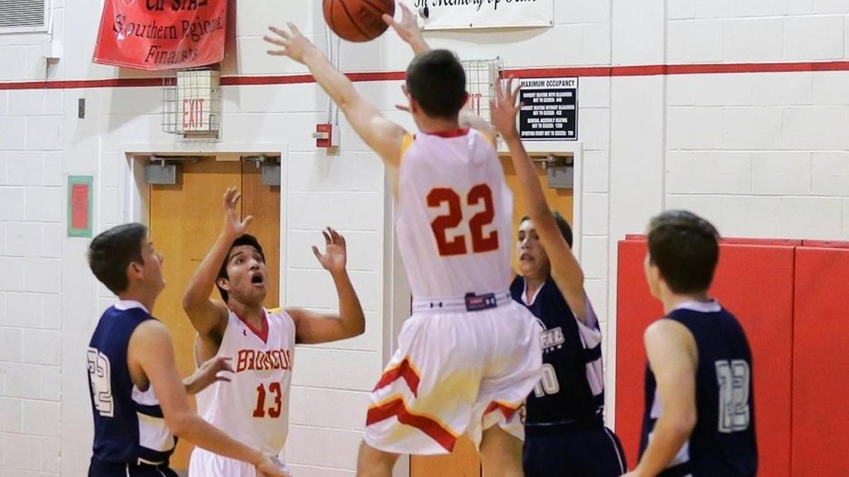 Sam MacKinnon (22) and Roberto Cueva (13) anticipate a rebound Feb. 9 in the Broncos’ 55-19 win over Coastal Christian.