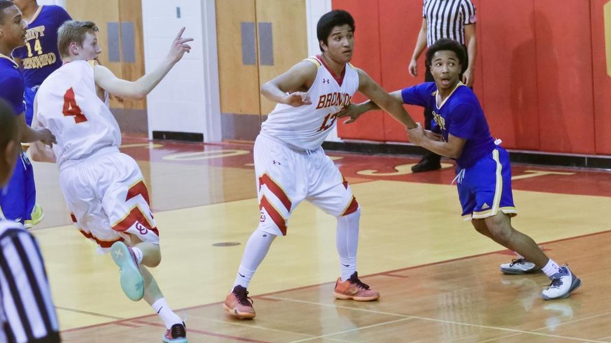 Coast Union center Roberto Cueva, who received honorable mention from the Coast Valley League, is grabbed by a Vikings player during Coast’s loss to St. Bernard in the second round of the CIF playoffs. Nick Roper (4) is alert for a rebound.