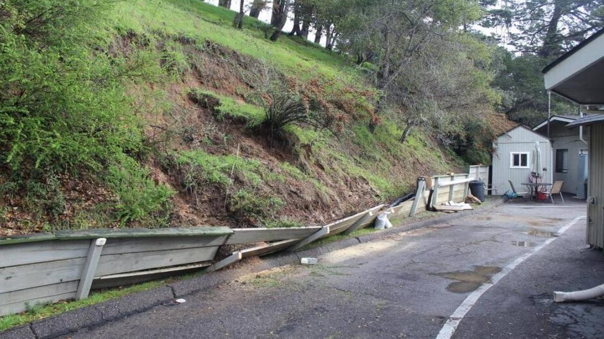 The collapsed debris wall, which is to be replaced, is seen at the ambulance station shortly after being knocked down during January’s rains.