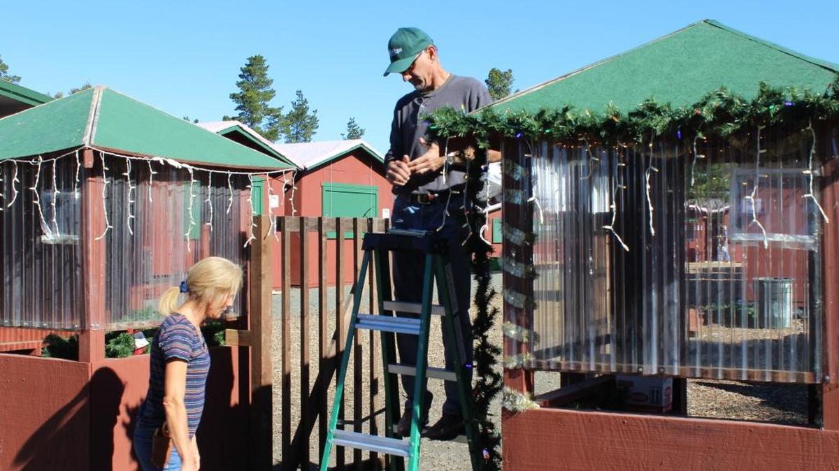Shana McCormick, left, and a coworker help get the Cambria Christmas Market put together on Thursday, Nov. 19, at Cambria Pines Lodge.