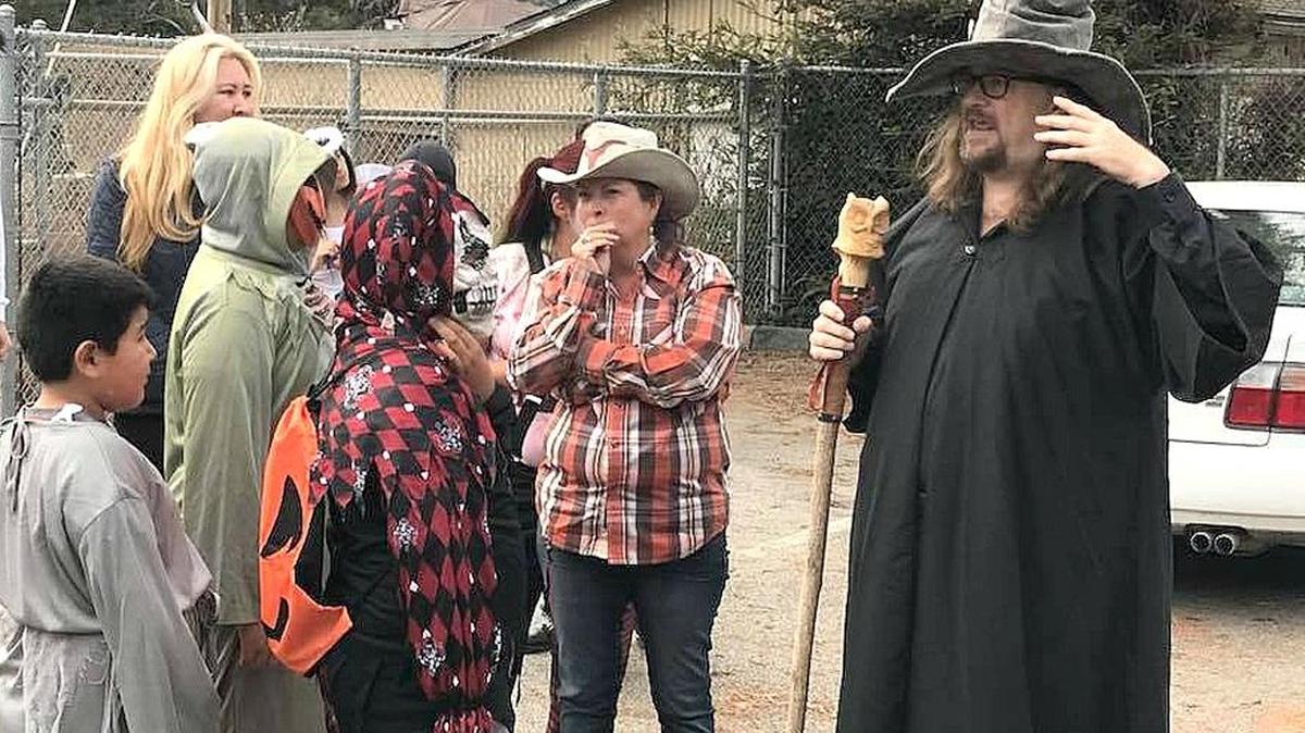 Rick Bruce, aka The Village Wizard, delivers instructions to trick-or-treaters and their parents in Cambria’s West Village on Tuesday, Oct. 31.