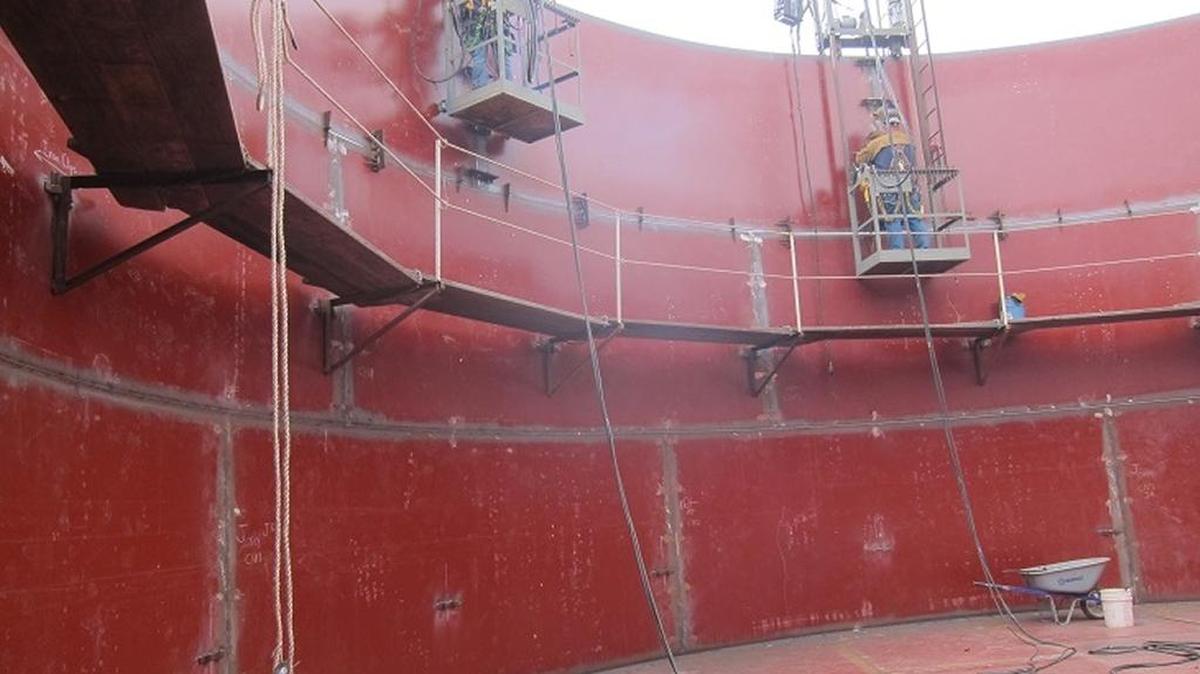Workers are seen welding the top shell ring inside the Fiscalini Water Tank.