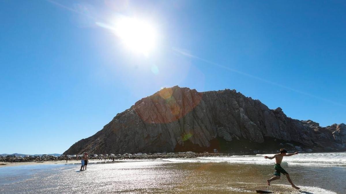Brady Baker, 15, vacations with family skim boarding on Morro Rock Beach. Temperatures in the county hit triple digits in many locations, including on Berwick Drive in Cambria.