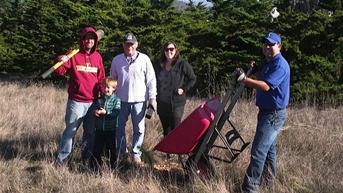 Three generations of the Snow family plant trees with Carlos Mendoza, Fiscalini Ranch Preserve manager, right.