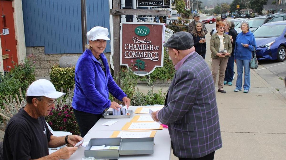 Stephen Gryte, left, and Peggy Christianson sell tickets to the Pinedorado Follies about 9 a.m. Monday in front of the Cambria Chamber of Commerce. Marvin Weitzenhoffer, right, is purchasing his.