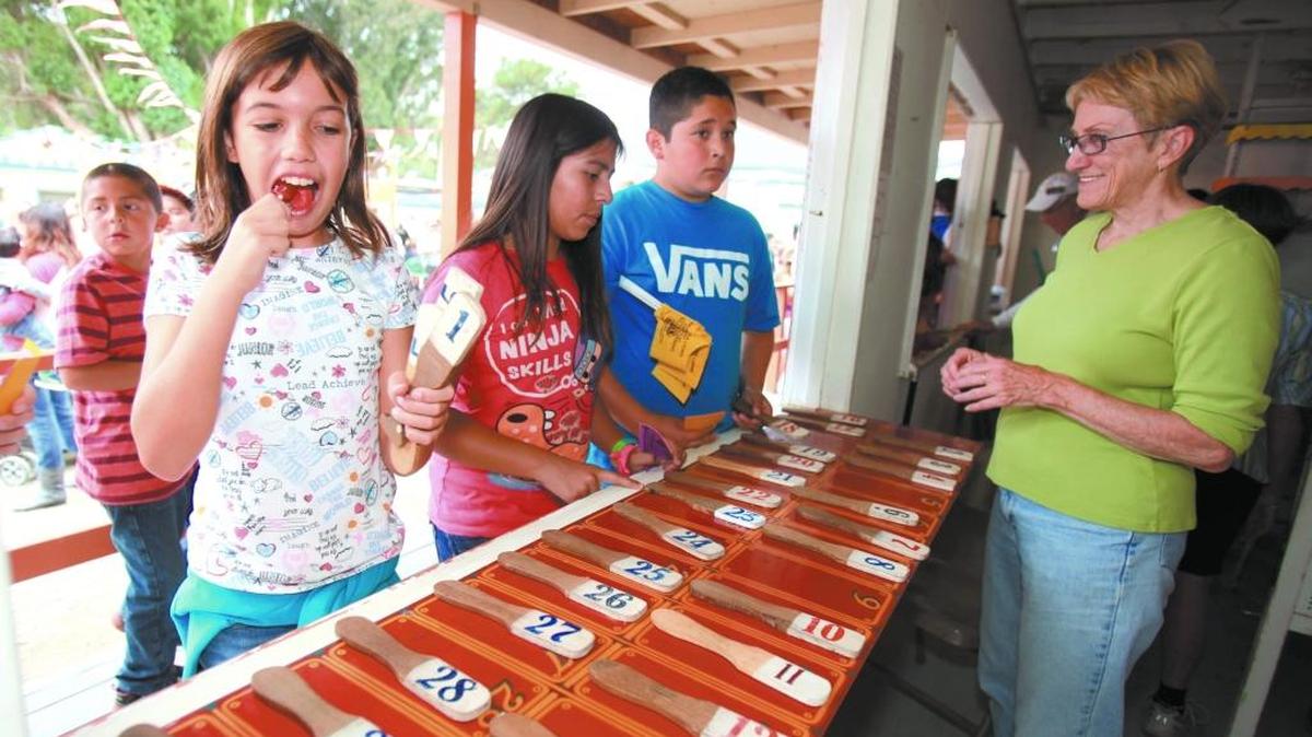 Jackie Happel, 11, of Cambria gets excited as she wins a prize in the “Wheel of Fortune” game in 2013. Behind her are Crystal Fabela, 10, and Cesar Hernandez, 11, both of Cambria. Pinedorado started out as a late-summer children’s festival, and there’s still plenty for children to do on the Pinedorado grounds.