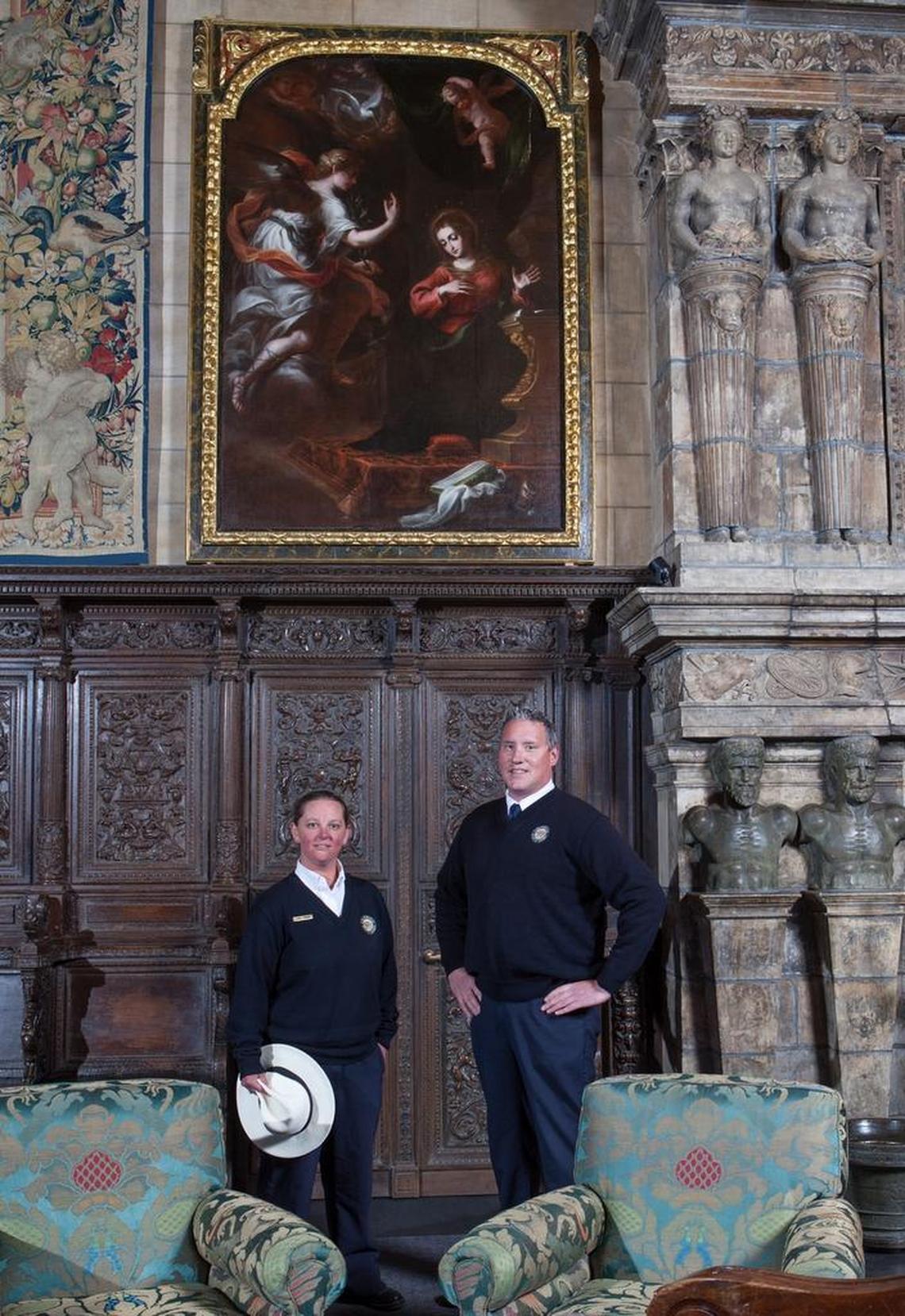 Hearst Castle guides Laurel Rodger and Carson Cargill stand near the “Annunciation” painting in the Assembly Room.