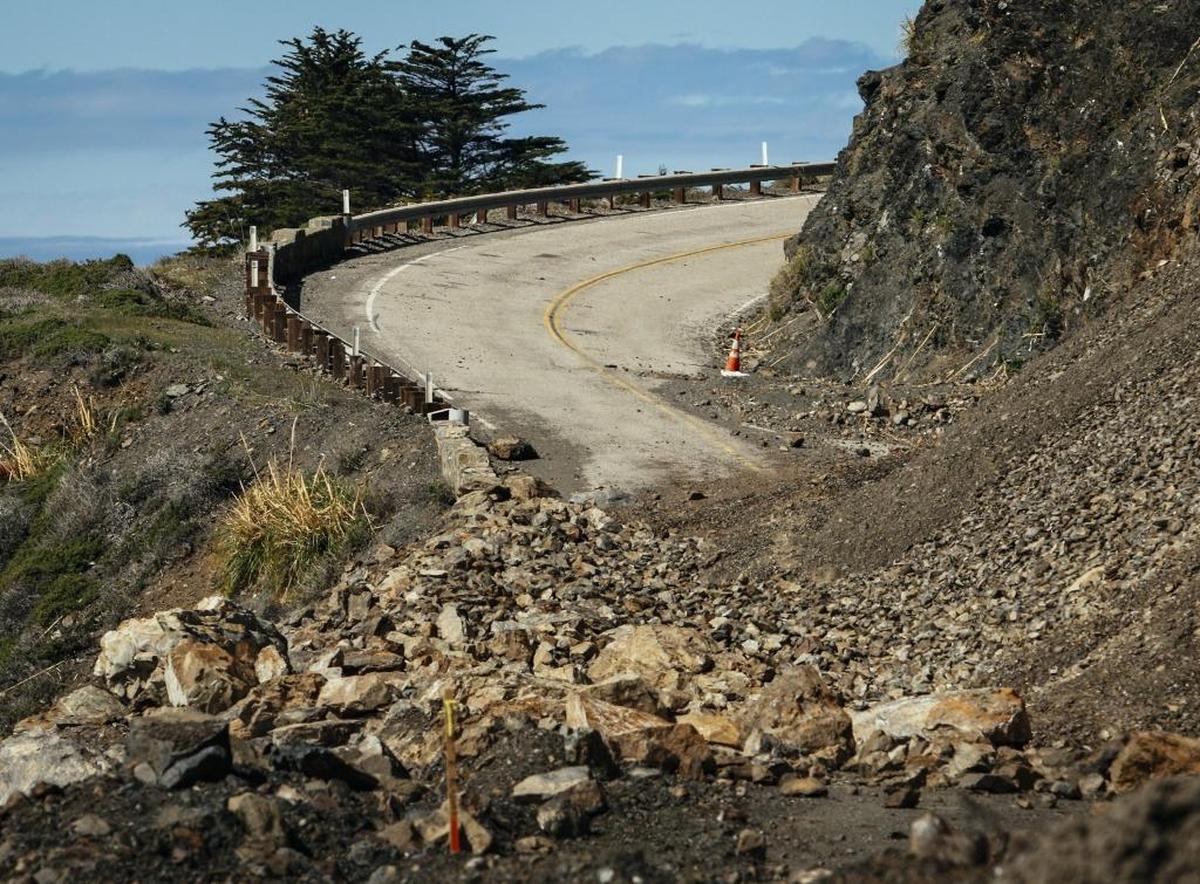 The temporary road near the north side of Highway 1 is covered in debris as work on the slope above continues to release loose debris.