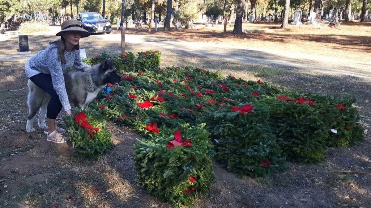 Glynda Hoskins gets ready to place a wreath in Cambria on Saturday, Dec. 16.