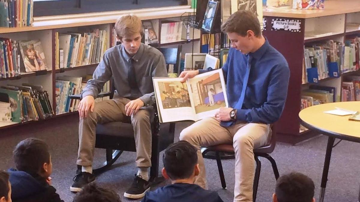 Coast Union student athletes Zach, left, and Will Stephenson read sports-themed books to Cambria Grammar School students to encourage them to play sports, and to attend Coast Union.