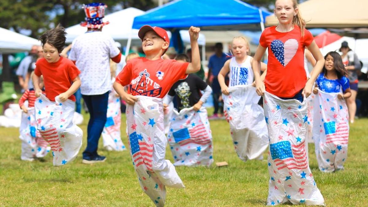 Kids compete in a sack race during Fourth of July events at Shamel Park in Cambria.