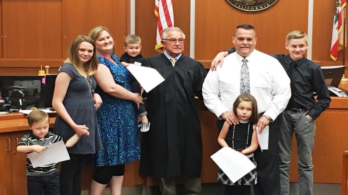 From left: Desmond, Kyla, Jandee and Adam Hollingsworth; Judge James Iwasko; William, Kaylee and Grant Hollingsworth on Aug. 31, 2016. The photo was taken in Santa Barbara after the judge finalized the Hollingsworths’ adoption of the three youngsters they had fostered for two years.